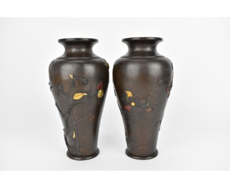 A pair of Japanese Meiji period patinated bronze vases, of tapered form with naturalistic relief decorations of birds in foli