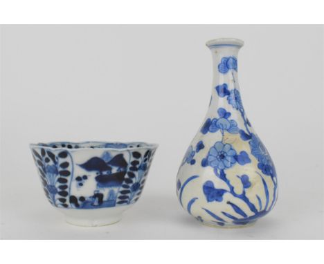A Chinese Kangxi blue and white tea bowl with a wary rim and tapered sides on a foot decorated to the exterior with alternati