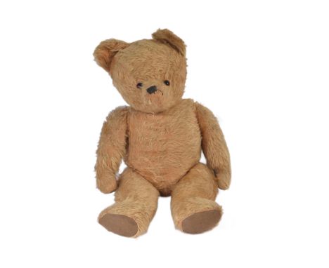 A large vintage English soft toy teddy bear, likely Chiltern or Chad Valley. The bear having golden mohair, beaded eyes and a
