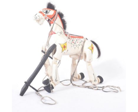A vintage hand made wooden horse marionette puppet in the style of Muffin The Mule. The puppet with moveable limbs, hand pain