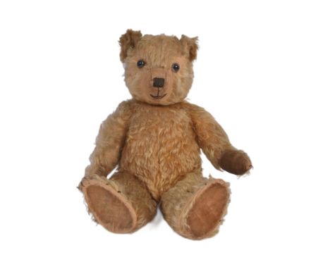 A vintage English soft toy teddy bear, likely Chiltern or Chad Valley. The bear having golden mohair, beaded eyes and a stitc