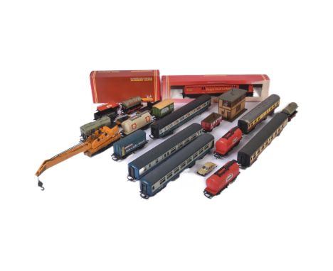 A collection of assorted OO gauge model railway rolling stock wagons and carriages. Largely Hornby and Lima examples to inclu