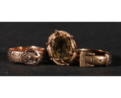 Two 9ct gold 'buckle' rings, 6.4g and a citrine set 9ct gold dress ring, maker HG, 4g.