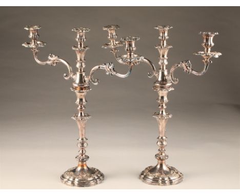 Pair large electro plated sliver three light candelabra, lobed circular based with foliate relief, twin scrolling branches, h