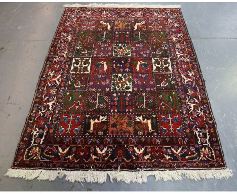 A Bakhtiari garden design rug, North-west Persia, late 20th century, the compartmentalized field enclosing vignettes of plant