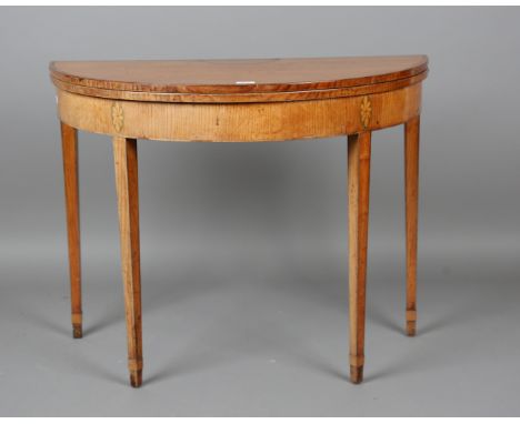 A George III ash demi-lune fold-over card table with crossbanded borders and inlaid conch shell, height 71cm, width 91cm, dep