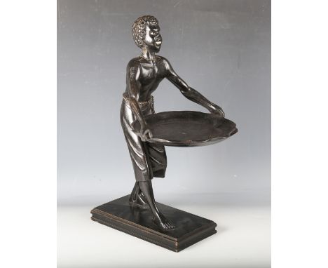 A late 19th century ebonized carved wooden blackamoor table-top visiting card tray, modelled in the form of a figure holding 