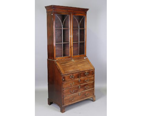 A George III mahogany bureau bookcase, the glazed top above a fall flap and an arrangement of oak-lined drawers, height 214cm