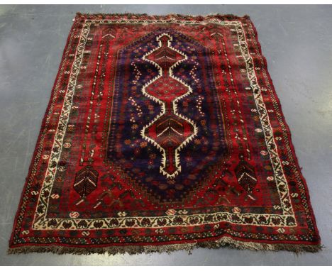 A Shiraz rug, South-west Persia, late 20th century, the blue field with a pole medallion, within a banded border, 182cm x 154