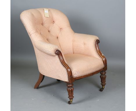 A William IV mahogany framed button back armchair, raised on reeded baluster legs and castors, height 90cm, width 78cm.Buyer’