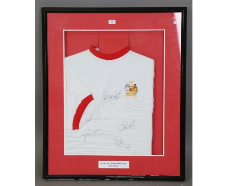 A vintage football shirt, signed by Manchester United footballers George Best, Dennis Law, Bobby Charlton, David Beckham and 