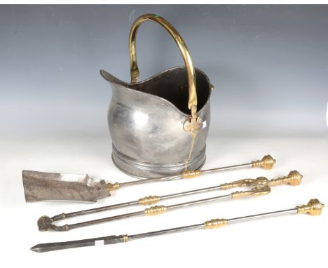 A set of late 19th century steel and brass mounted fire tools with turned spherical handles, shovel length 66cm, and a steel 