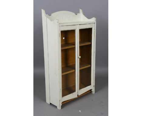 An early 20th century painted pine glazed bookcase, height 120cm, width 65cm, depth 28cm.Buyer’s Premium 29.4% (including VAT