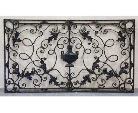 A late 19th century wrought iron rectangular balcony panel, finely worked with applied leaves and a central urn within scroll