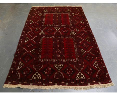 An Afghan ensi rug, mid/late 20th century, the compartmentalized field enclosing stylized candelabra, within a gul border, 25