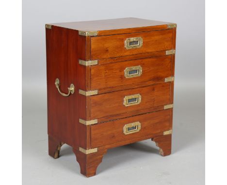 A late 20th century yew and brass bound campaign style bedside chest of four drawers, height 59cm, width 46cm, depth 30cm.Buy