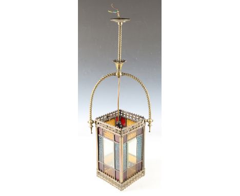 A late 19th century stained glass hanging lantern of rectangular form, the pierced brass trellis frame suspended on an overhe