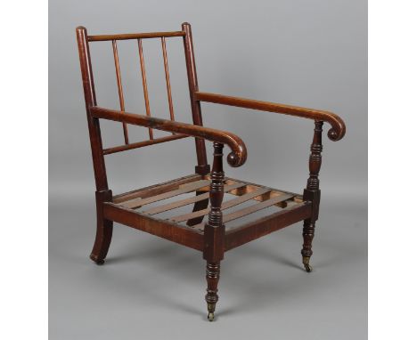A George IV mahogany framed armchair, raised on ring turned legs and castors, height 95cm, width 59cm, depth 80cm. Provenance