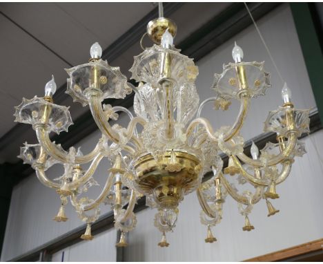 A large 20th century Murano glass twelve-light chandelier, fitted with daffodil and leaf mounts, each branch hung with a gilt