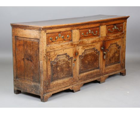 A late 18th century provincial oak dresser base, fitted with three drawers above three arched panels, on bracket feet, height