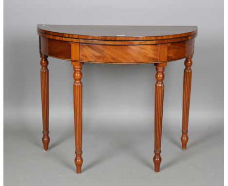 A William IV figured mahogany demi-lune fold-over card table with ebony stringing, height 75cm, width 92cm, depth 45.5cm.Buye