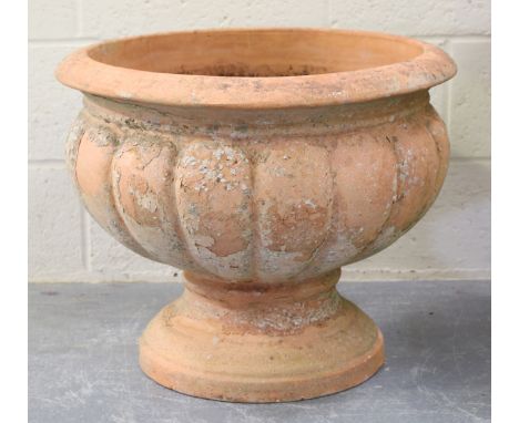 A 20t century terracotta garden urn with a lobbed circular body on a spreading circular foot, height 50cm, diameter 62cm.Buye