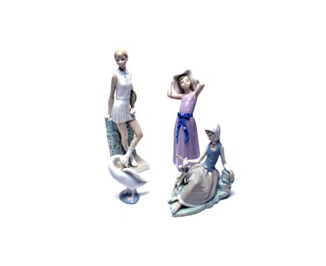 A collection of Lladro ceramic figures, comprising: girl with tennis racquet, 32cms high; girl with bird; girl with hat; and 