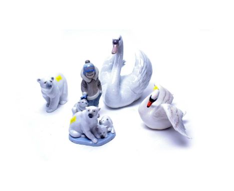 A Lladro ceramic swan figure, 19cms high; together with a Lladro polar bear; Lladro polar bear and cubs figure group; and a L