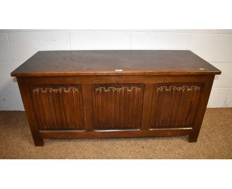 A mid-20th Century carved oak coffer, with linenfold panels to front, 113 x 44.5 x 54cms; and an Edwardian commode stool, 45 