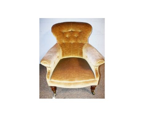 A Victorian button-back armchair, upholstered in gold plush material, on walnut legs with "Cope &amp; Collinson patent" brass