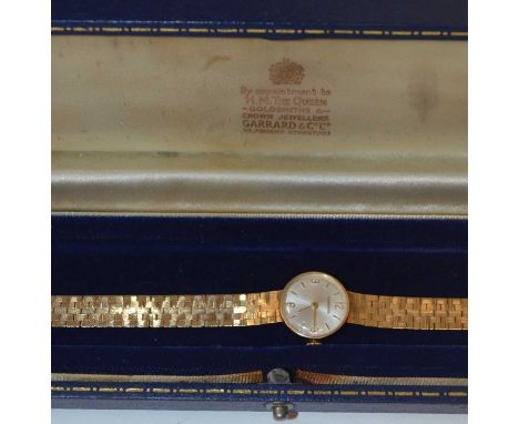 Garrard: a 9ct yellow gold cocktail watch, the baton and arabic dial with manual wind movement, on textured link strap, engra