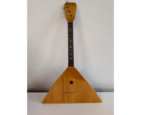 A vintage Russian Balalaika wooden stringed musical instrument, shipping unavailable