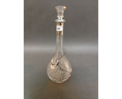 A glass decanter with silver collar, marked 800 and "Champaigne" label. 