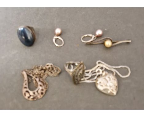 A selection of hallmarked silver jewellery items to include a marcasite ring, a brooch, earrings, two chains with pendants an