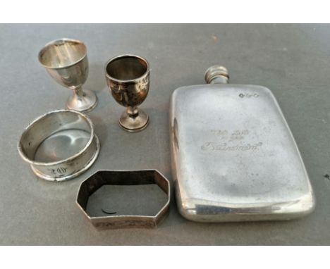 A selection of hallmarked silver items to include a napkin ring and two small trophies / cups together with a pewter flask, m