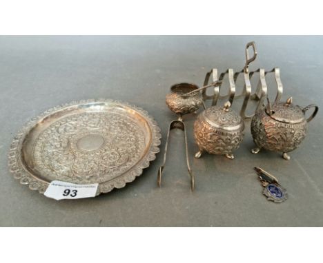 Four Anglo-Indian white metal objects, Kutch, comprising a salver with pierced raised rim, a globe shaped pepper pot, a salt 