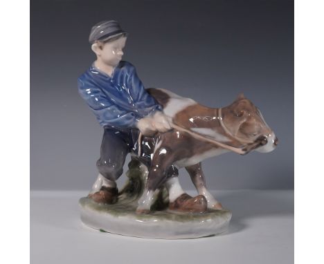 Royal Copenhagen porcelain figurine Boy with Calf, style number 772. This hand-painted piece captures a rural moment with a y