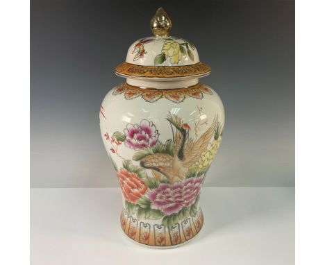 This is a stunning Japanese-style hand painted porcelain covered jar with an plum-shaped silhouette. The jar features intrica