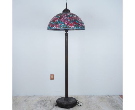 This elegant Tiffany-style floor lamp features a large dome-shaped stained-glass shade with a stunning floral motif. Handcraf