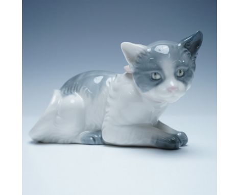 Charming Nao by Lladro porcelain figurine featuring a lifelike gray and white cat in a resting pose, adorned with a delicate 
