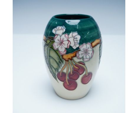 Moorcroft pottery vase featuring a vibrant cherry blossom design. This exquisite hand-decorated piece showcases raised tube-l