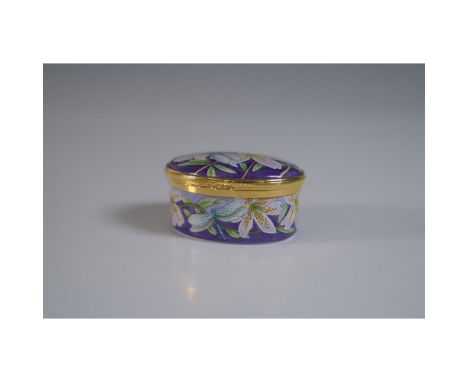 Moorcroft porcelain trinket box featuring a vibrant hand-painted design of dragonflies and lilies against a rich purple backg