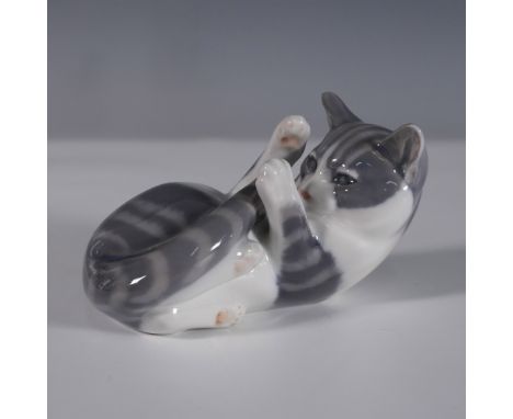 Charming Royal Copenhagen porcelain figurine depicting a playful gray and white striped cat lying on its back with its paws r