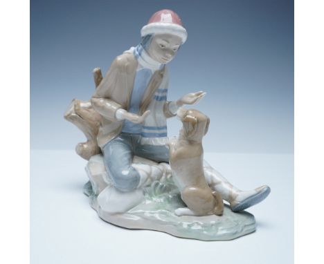 Charming Nao by Lladro porcelain figurine depicting a young boy in winter attire seated on a log, interacting with his playfu