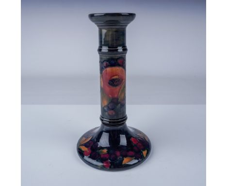 A beautiful Moorcroft ceramic candlestick featuring the iconic Pomegranate and Berries pattern. Hand decorated in a rich pale