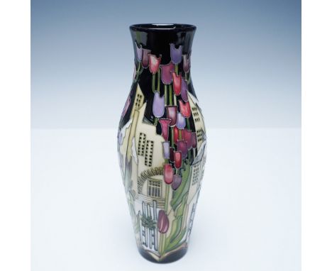 A rare Moorcroft trial vase featuring a stunning design of vibrant tulips cascading down a stylized cityscape. This hand-pain