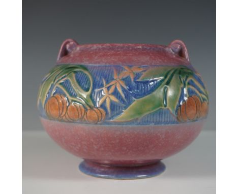 Roseville Pottery jardinière in the pink Baneda pattern. This design features a rounded form with a footed base and two small
