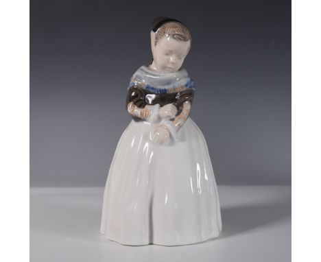 Charming Royal Copenhagen porcelain figurine, model 1257, featuring a young girl knitting. Designed in the traditional Danish