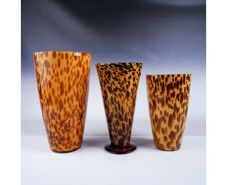 A set of three spotted amber art glass vases featuring a vibrant pattern of brown and golden hues. The largest vase measures 