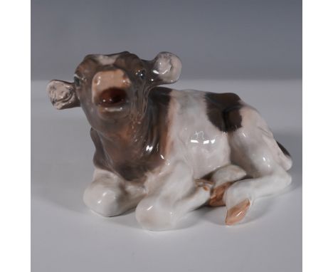 Royal Copenhagen porcelain figurine depicting a lying calf, model number 1072. This finely crafted piece features a lifelike 